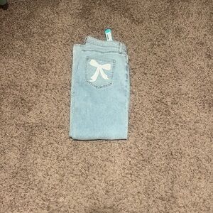 Chic Light Blue Flare Jeans with Bow Accent